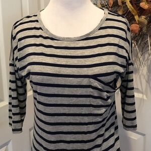 Gray and blue striped top.